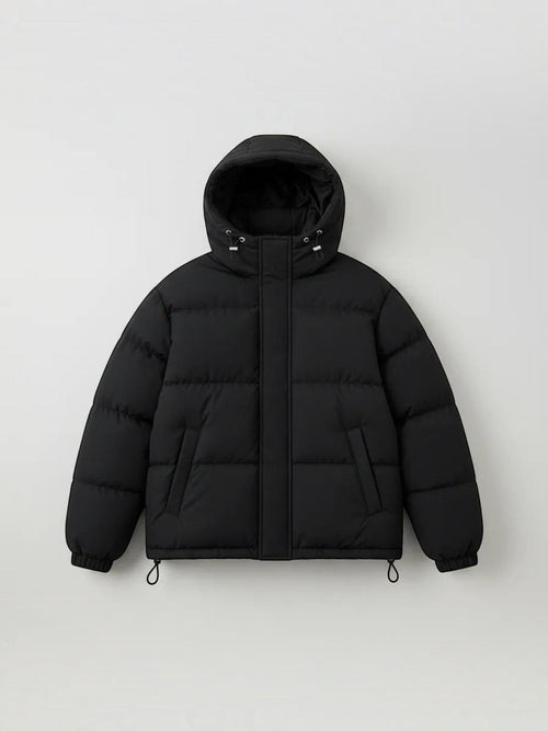 Chaqueta puffer negra unisex cozyvibe con capucha, diseño acolchado oversize y cierre frontal para invierno